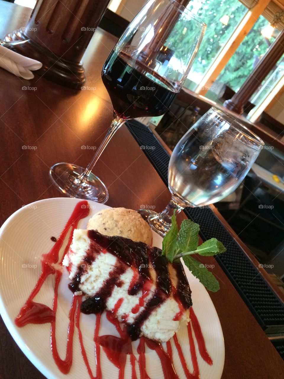 Raspberry drizzled New York style cheesecake with a glass of Merlot. Koko's restaurant on Alderbrook golf course.