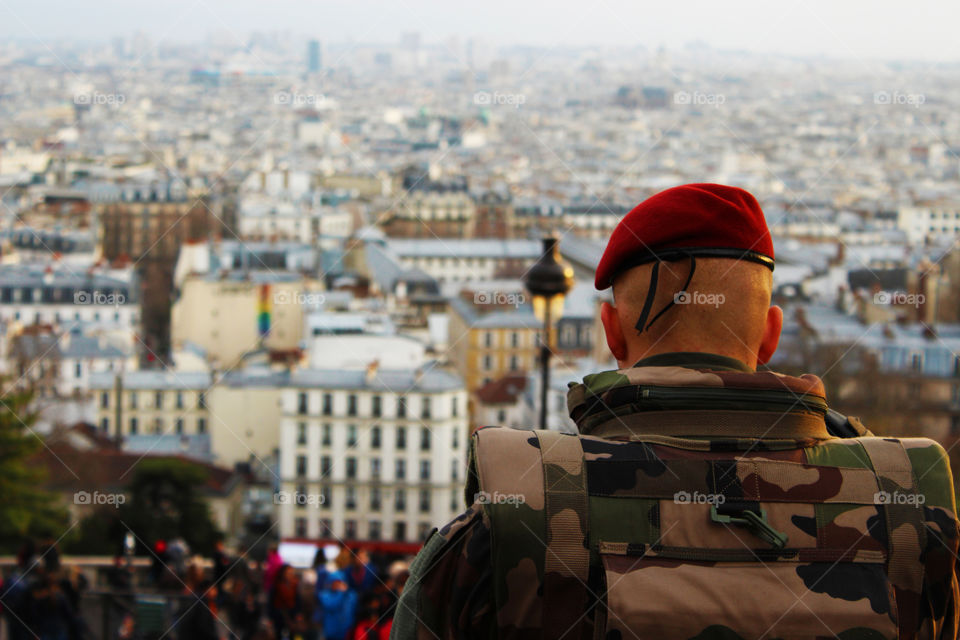 Soldier looks the urbanscape from the MONTMATRE hill.France