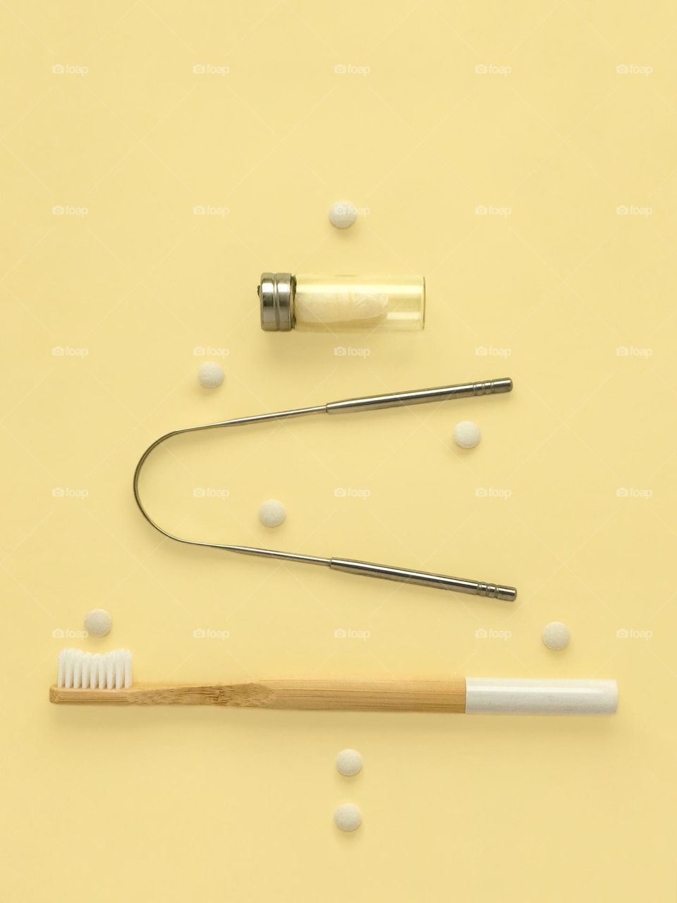 Bamboo toothbrush, tongue cleaner, dental floss, tooth powder tablets. Creative eco Christmas tree.