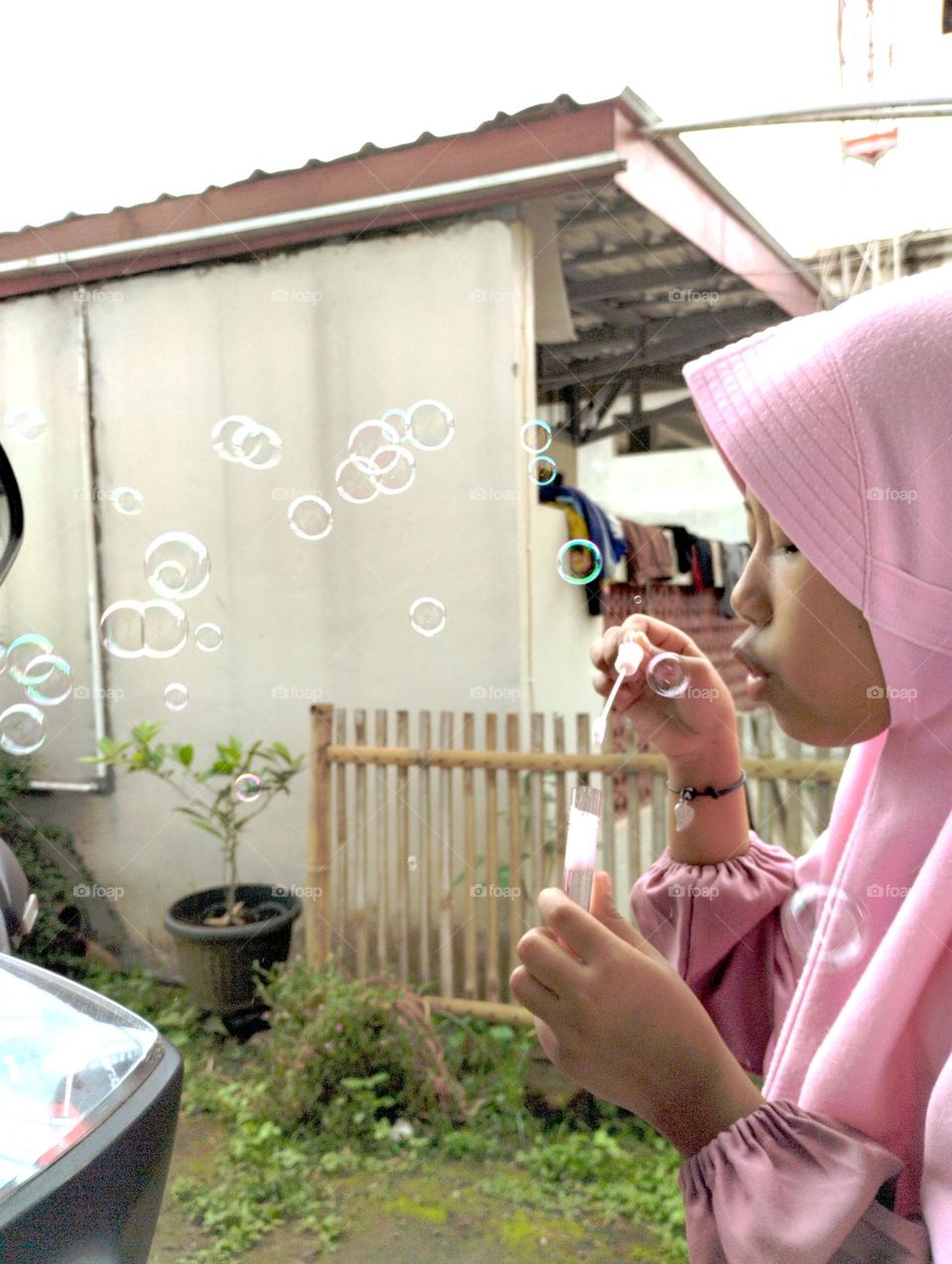 the little one is playing with bubbles
