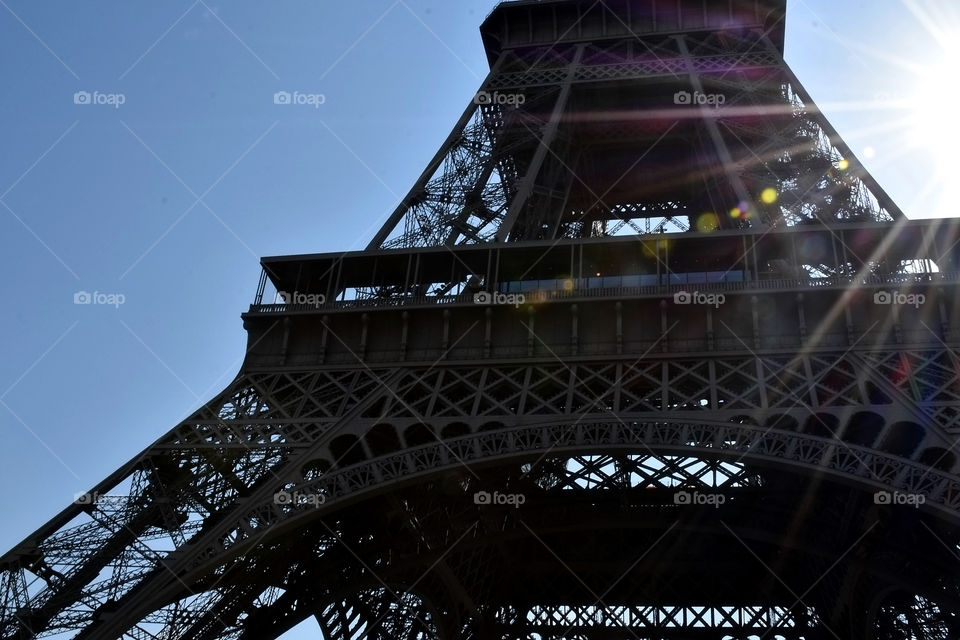 Sun streaming through the Eiffel Tower 