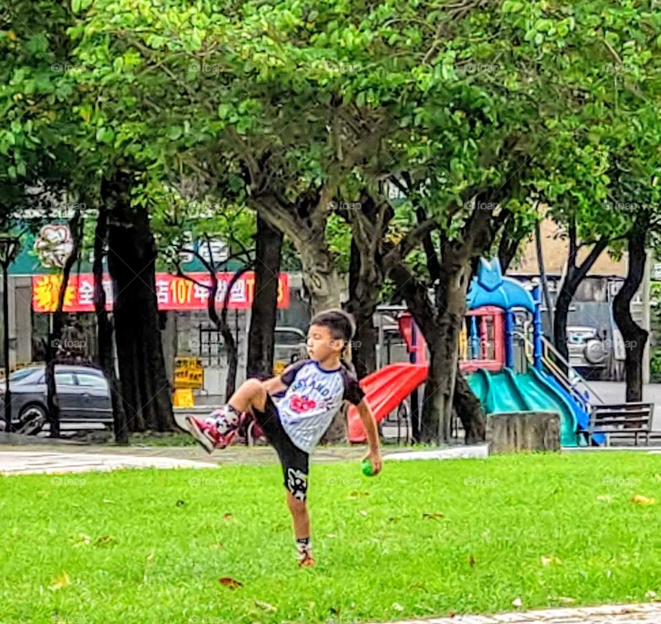 staying in good shape: a boy's pitching posture of playing basketball .