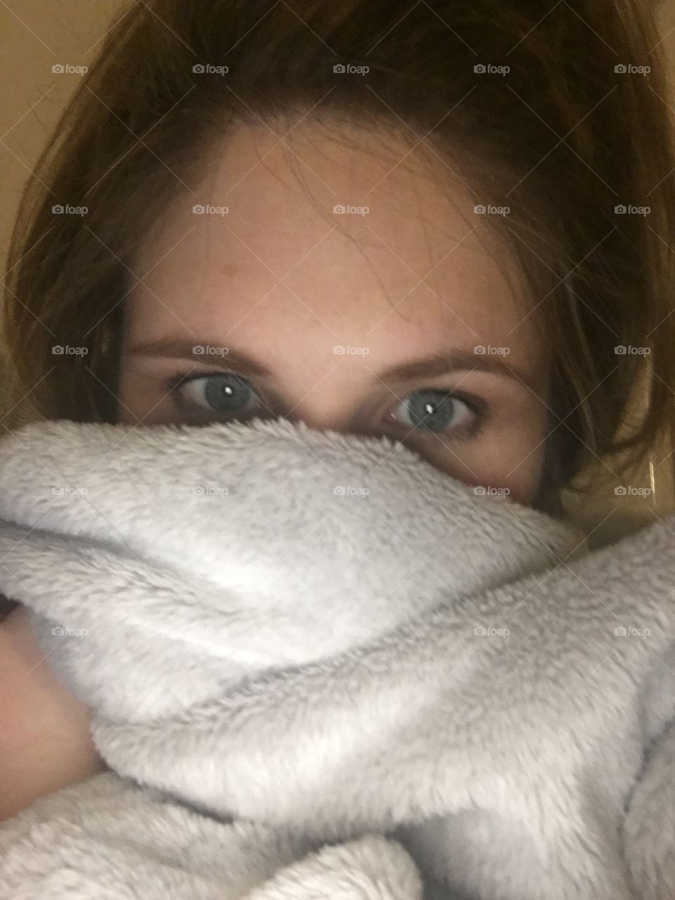 Young woman hiding her face with towel