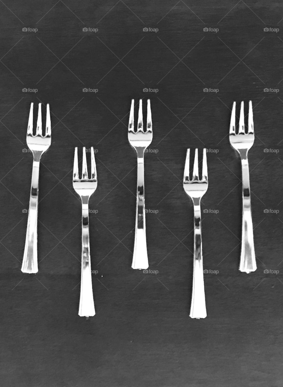 An elegant table top display of five mini silver forks getting prepared for the holiday dinner celebrations - fall, autumn, holiday seasons, Halloween, Thanksgiving