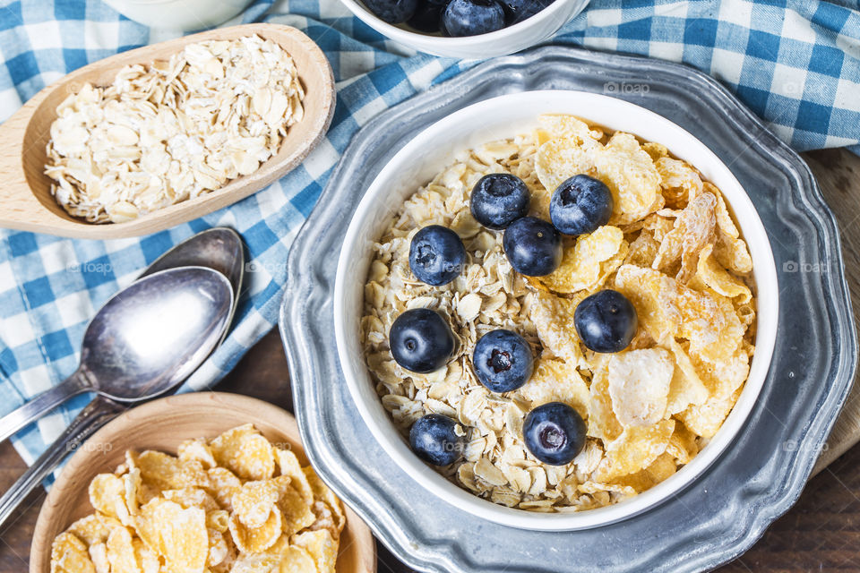 Top view of breakfast with cereals, muesli and berries