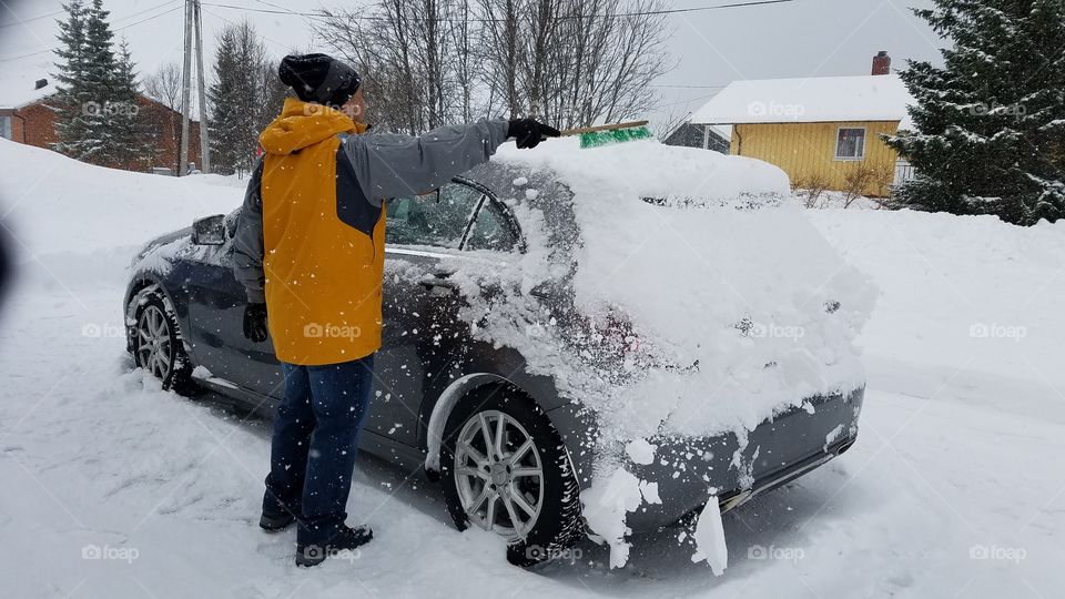 Scrapping snow off the car