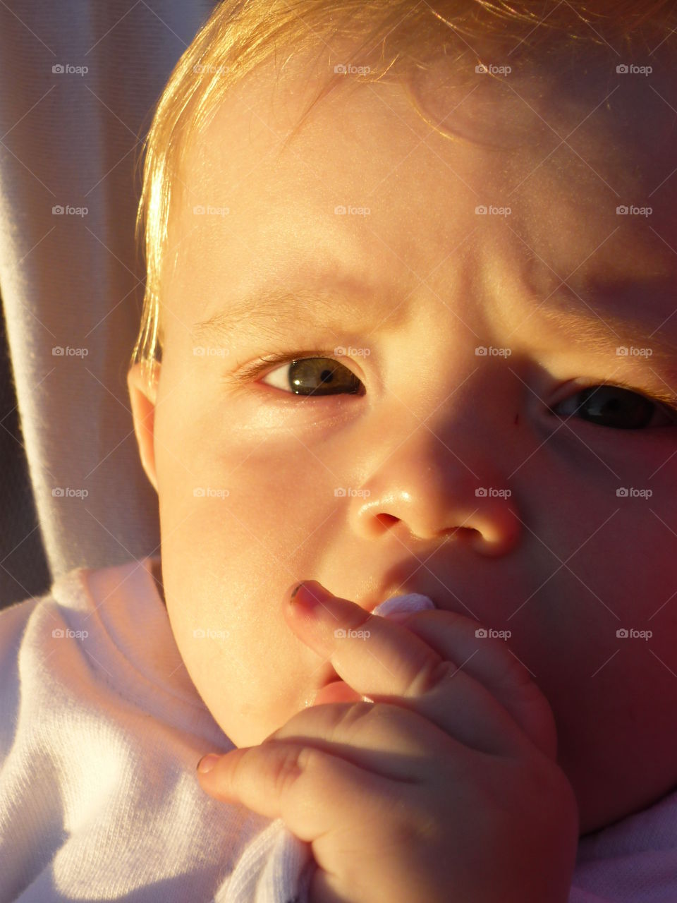 baby thinking on sunrise