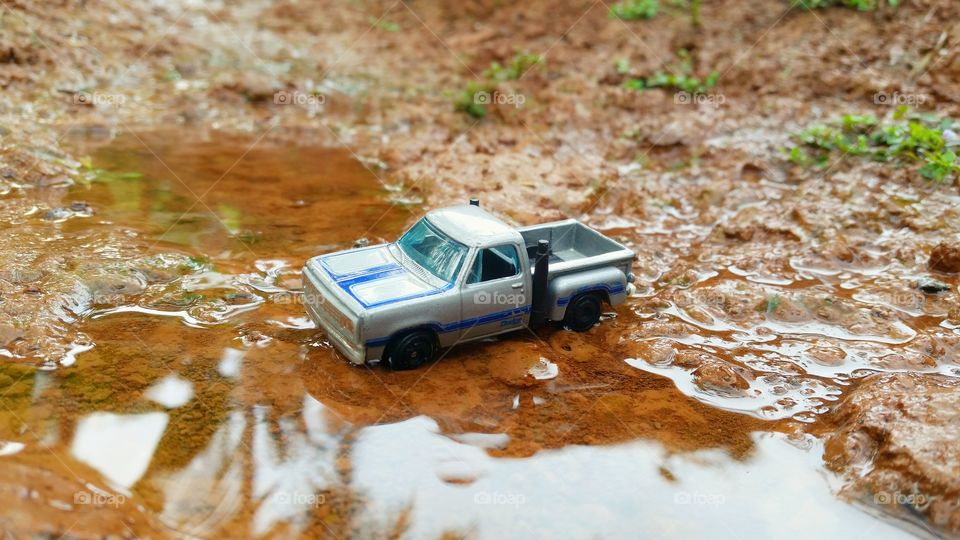 miniature truck cars that are crossing the river