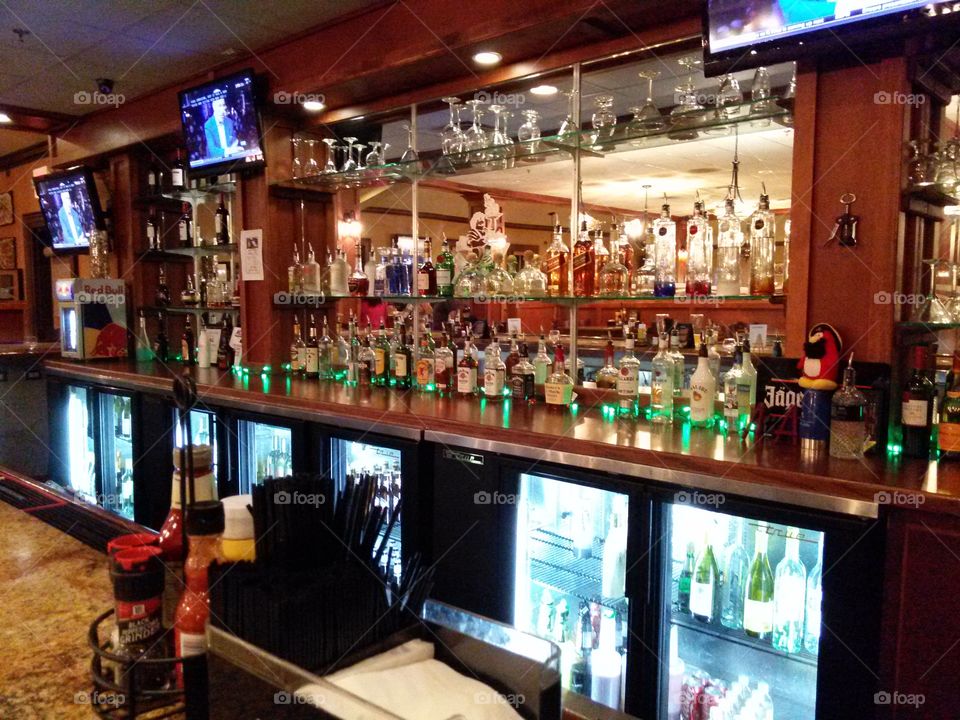 fully stocked. image of a fully stocked bar, liquor bottles etc