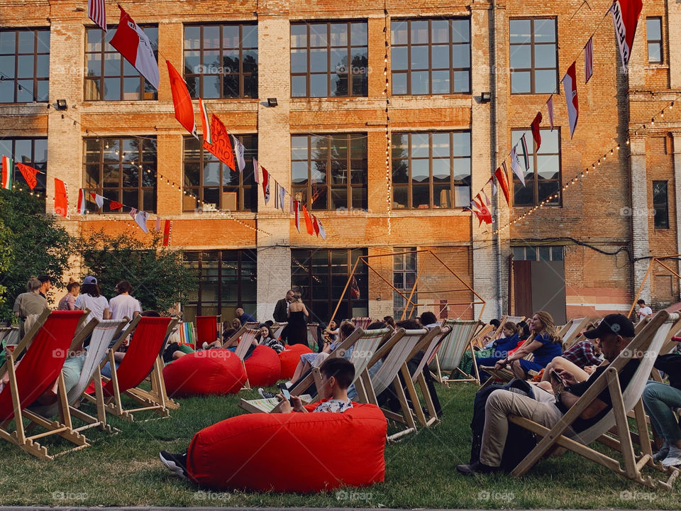 People relaxing on the chairs on music festival
