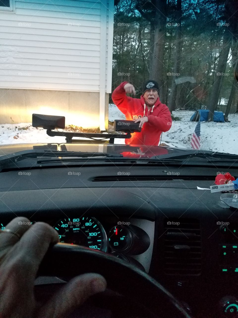 Getting hand signals to drive into plow & hook it up. Hubby outside, wifey inside with controls. Snowstorm  coming.