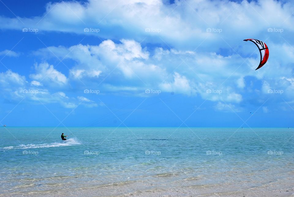 Man Kite Surfing in paradise, summer vacation 