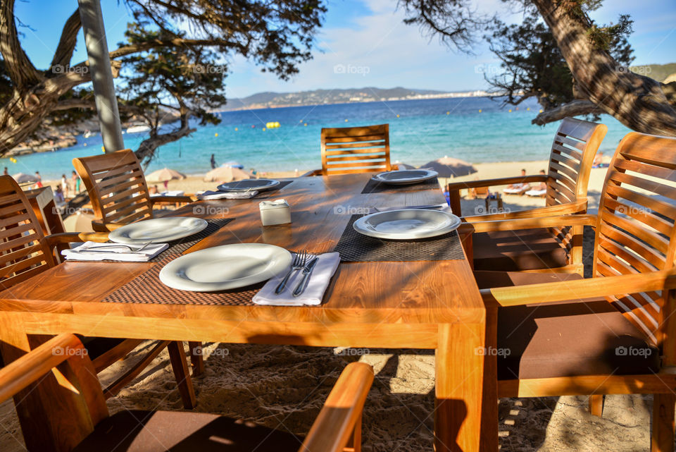 Place setting on table at beach