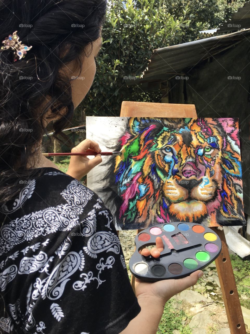 girl painting a painting of a lion. Art