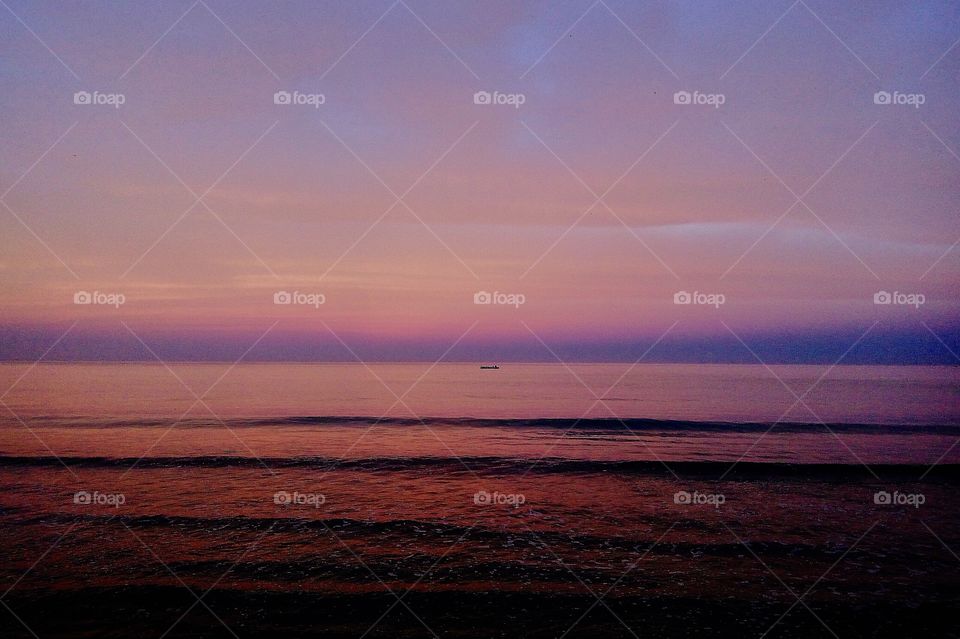 Early morning color gradient of the sky and sea.