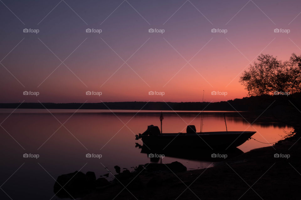 Foap, Landscapes of 2019: Silhouette of a fishing boat against the early morning twilight sky at Fall Lake near Raleigh North Carolina.