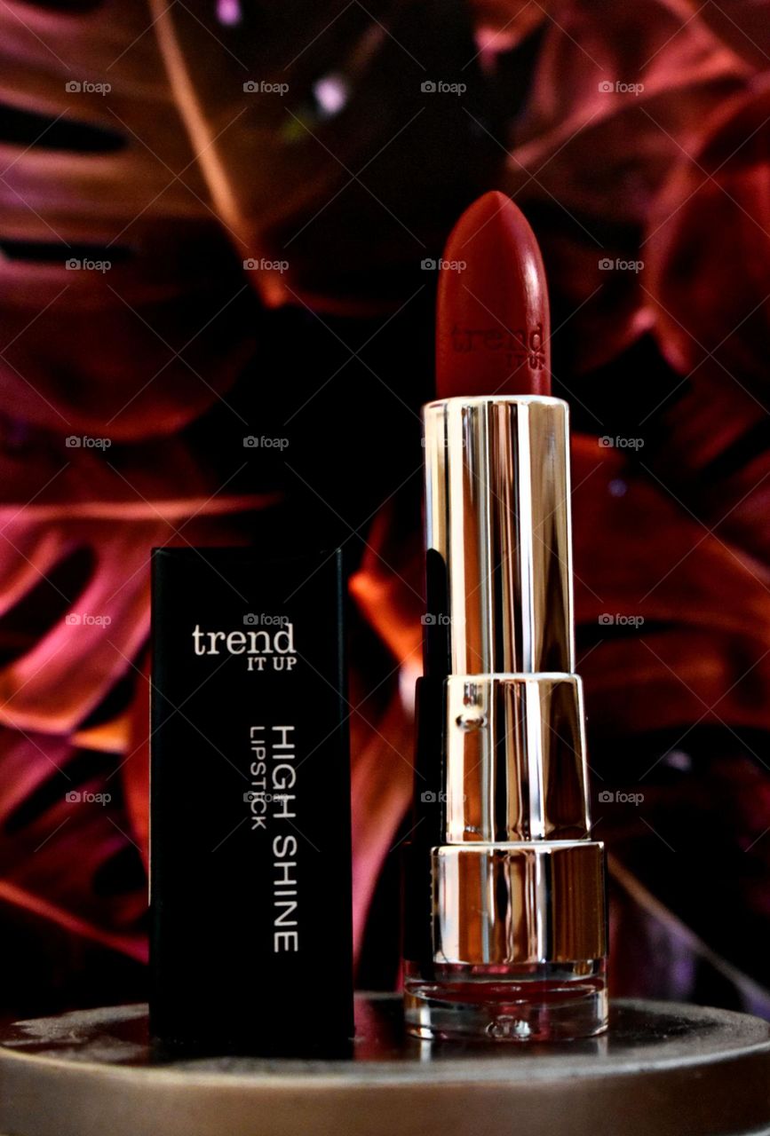 Red lipstick with tropical Red background.