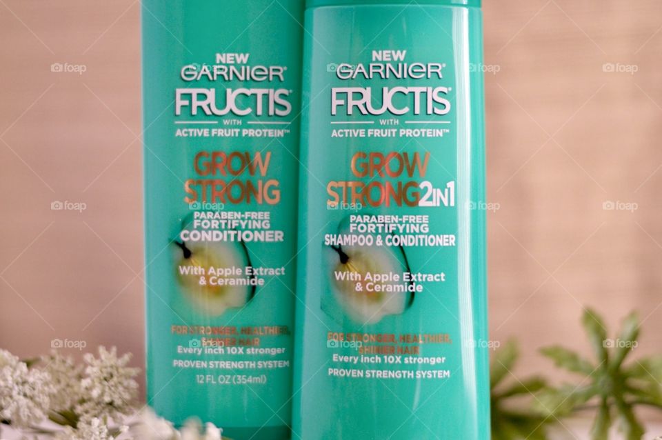 Garnier grow strong conditioner and shampoo Flat lay on a white background