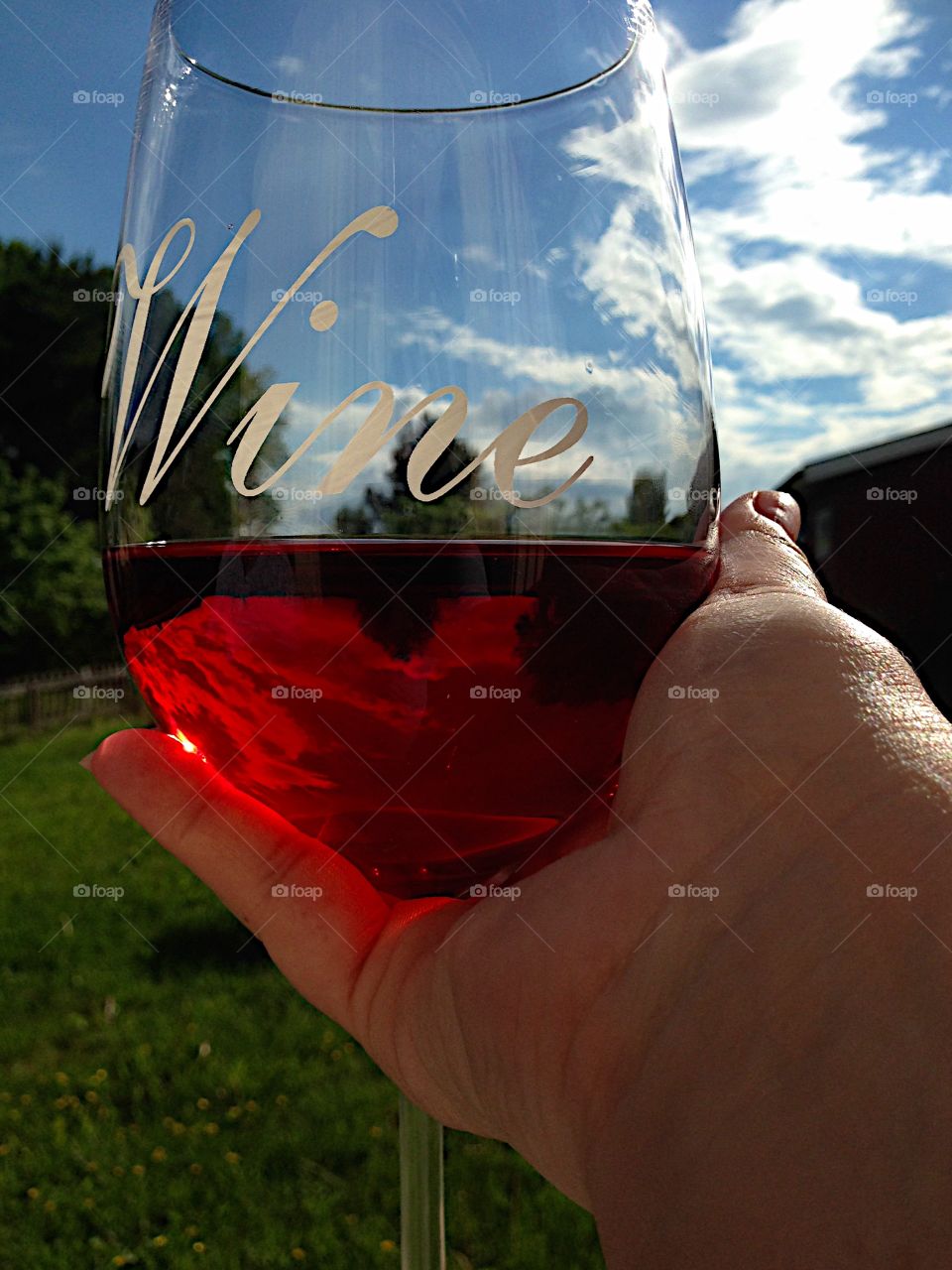 Holding a glass of wine!