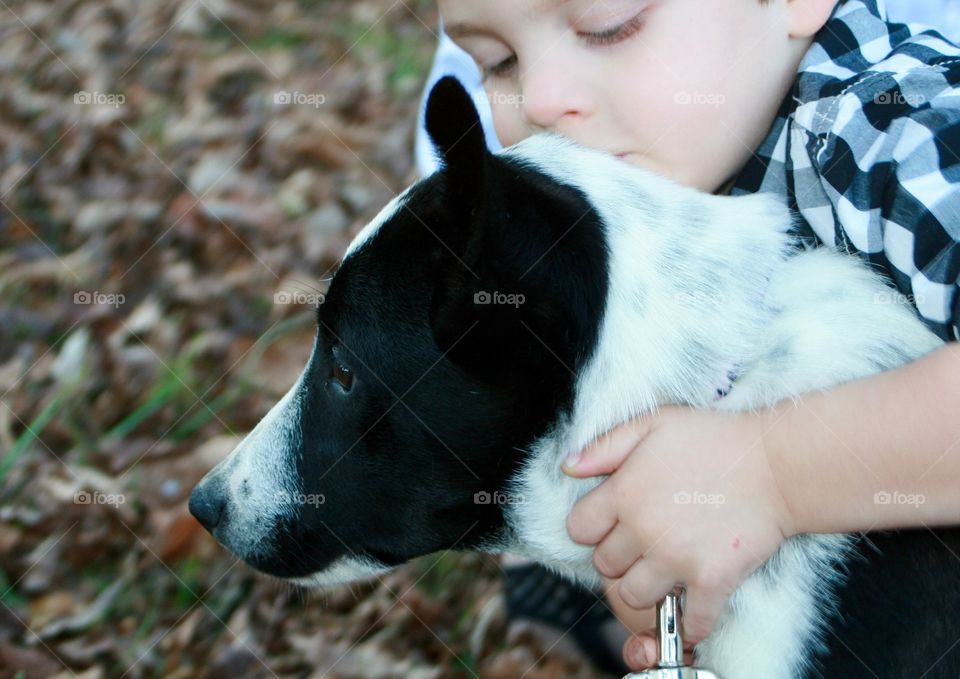 A boy and his puppy. 
