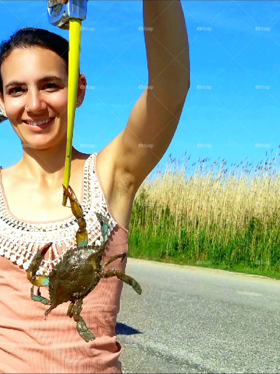 a beautiful woman showing off her large Blue Crab caught off of the Gulf of Mexico near Bridge City Texas United States of America 2018