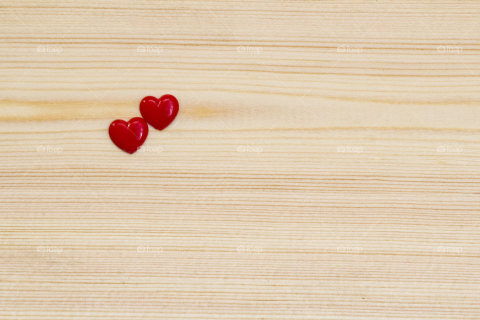 two hearts on a wood background