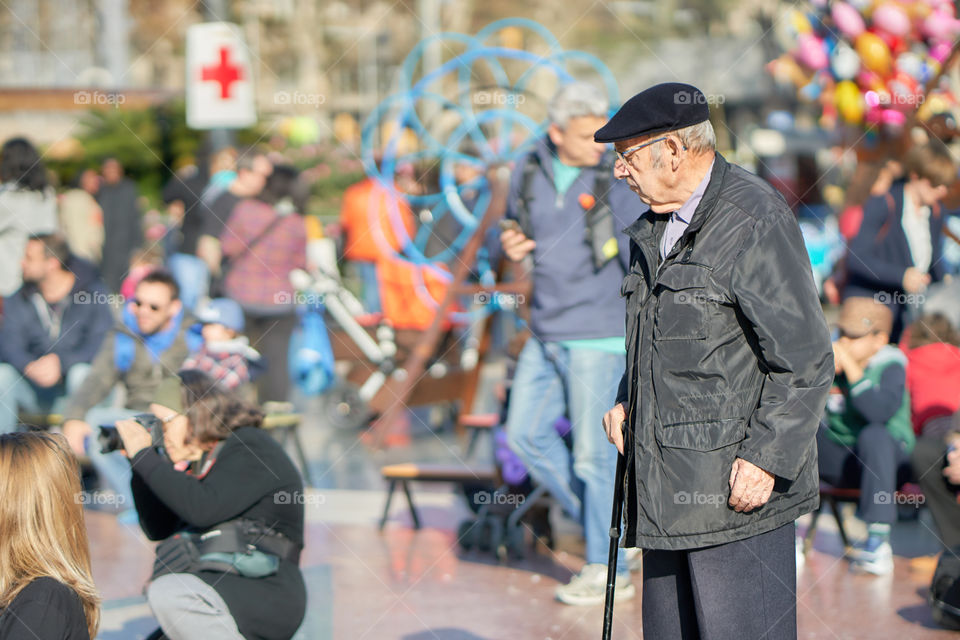 Elderly man in a crowd square 