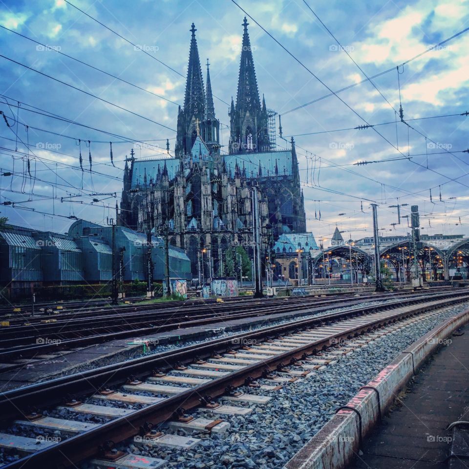 Cologne cathedral and central train station at dusk 
