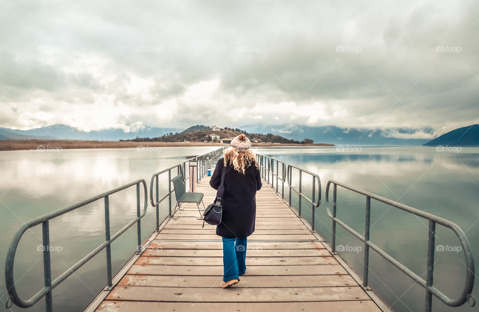 Wanderlust Young Woman Walking On Bridge Toward The Island
