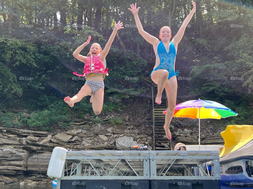 A mother and daughter jumping into lake Cumberland 