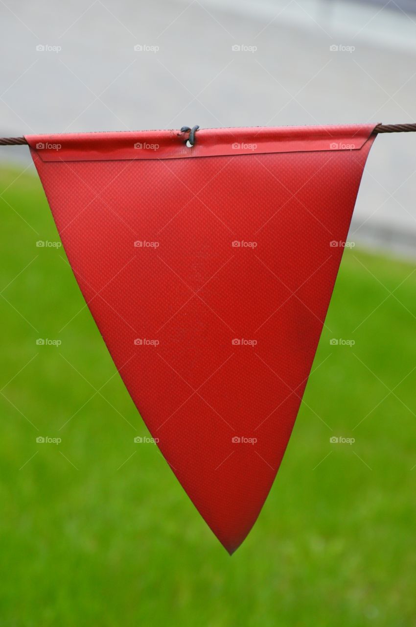 red flag in green background