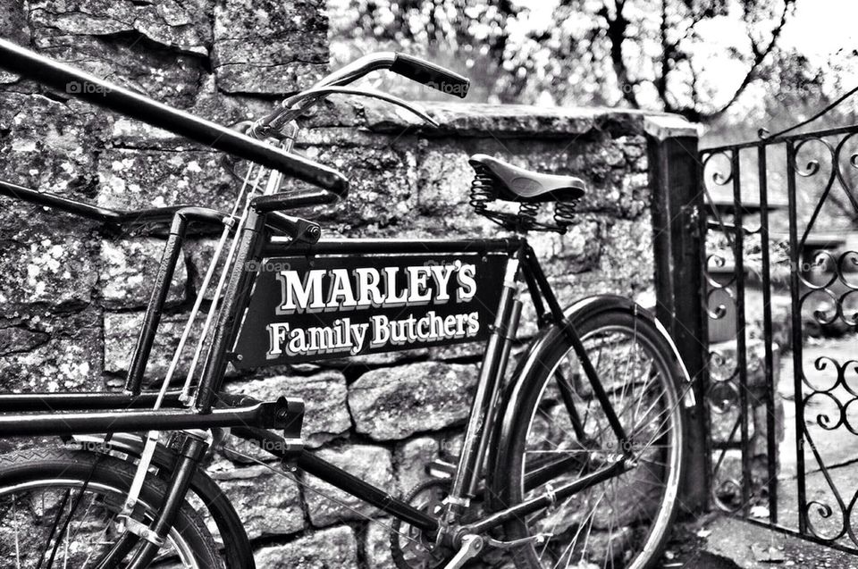 Black and white shot of a traditional butcher's bicycle leaning
