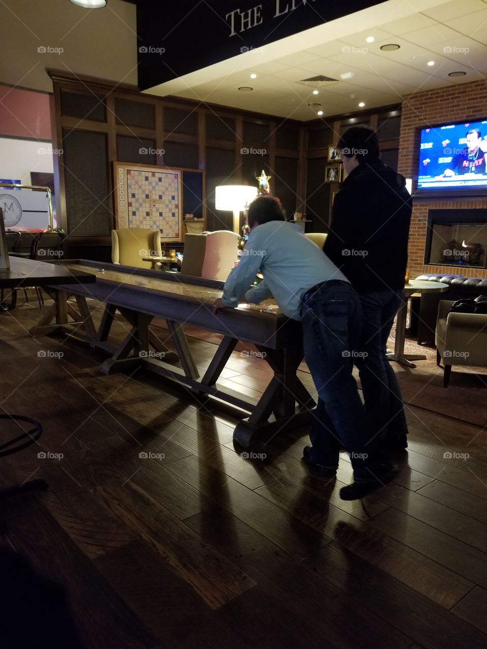 Table shuffleboarding fun at bar