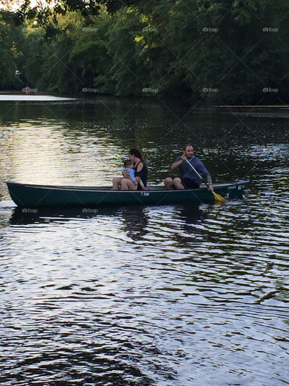 Family enjoying boating in lake