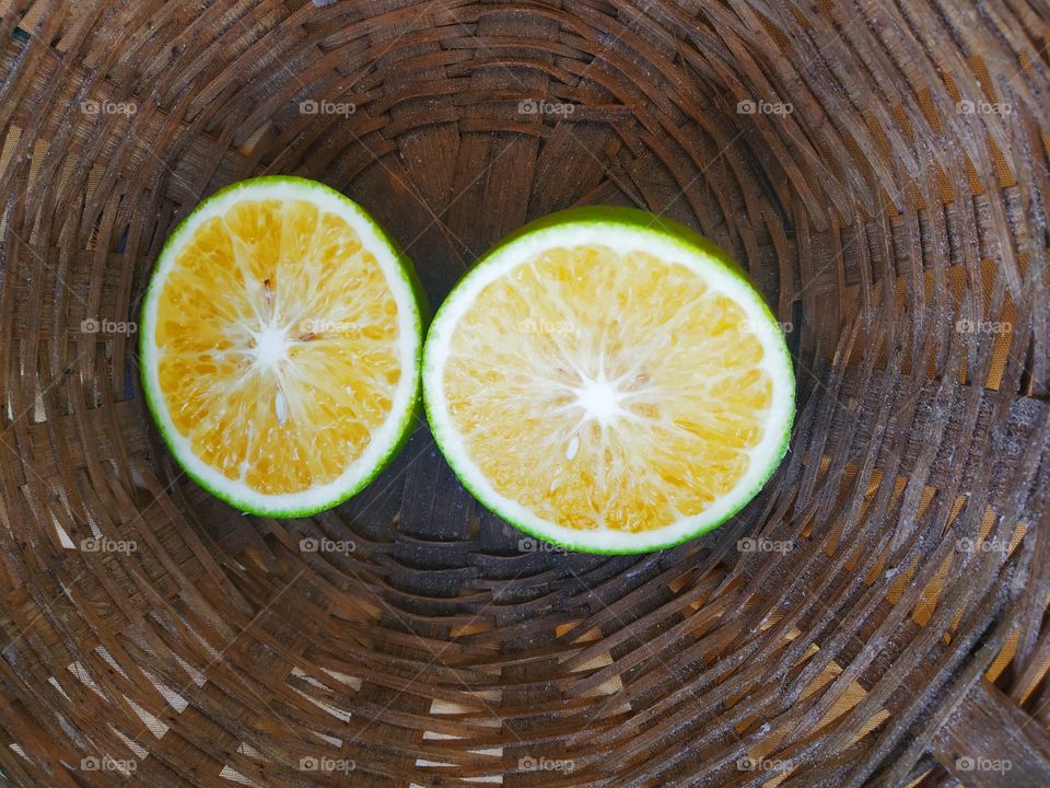 sweet lime ( mosambi ) Fresh ripe slices isolated on a Wooden background
