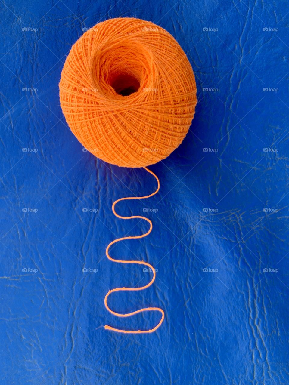 Orange cotton ball in a blue background 