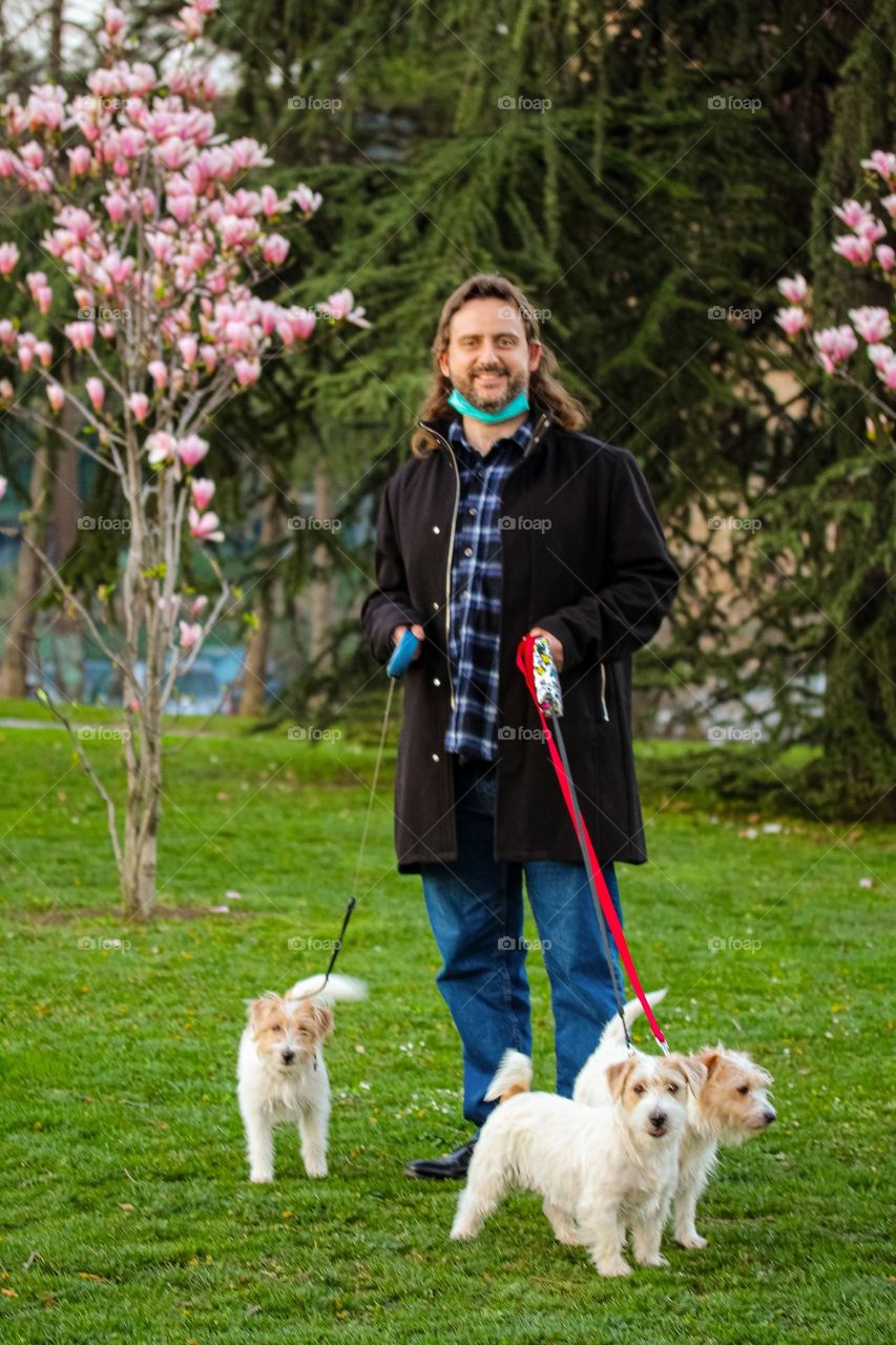 Portrait of a man in nature with puppies