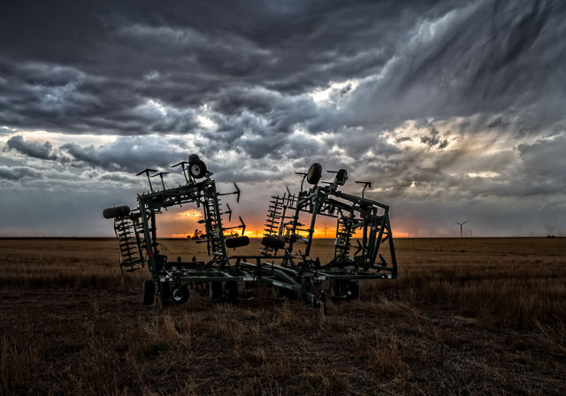 Harrows in a stormy sunset, Kansas