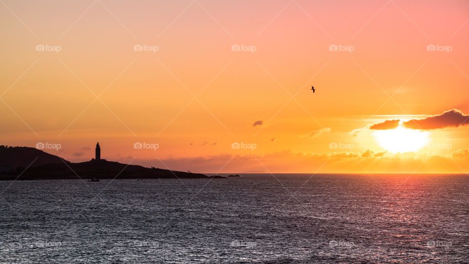 Sunset with lighthouse at the background