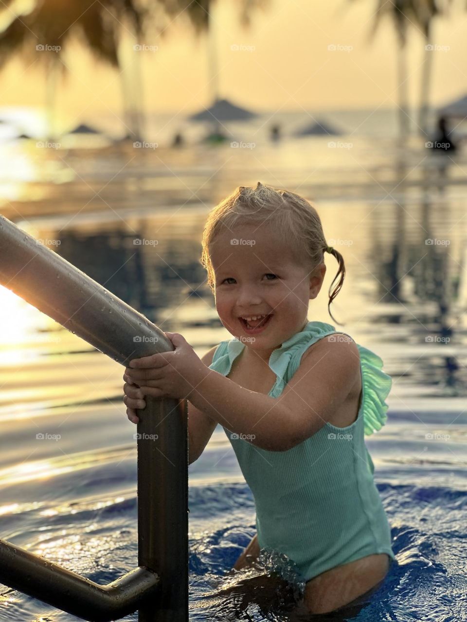 Cute baby girl in swimming pool