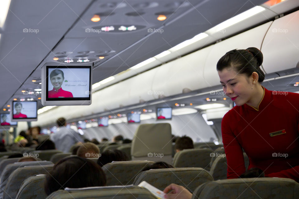 Air hostess taking care of a passenger. in flight customer service