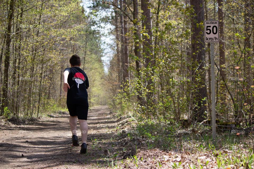 Person running in the woods in the spring time