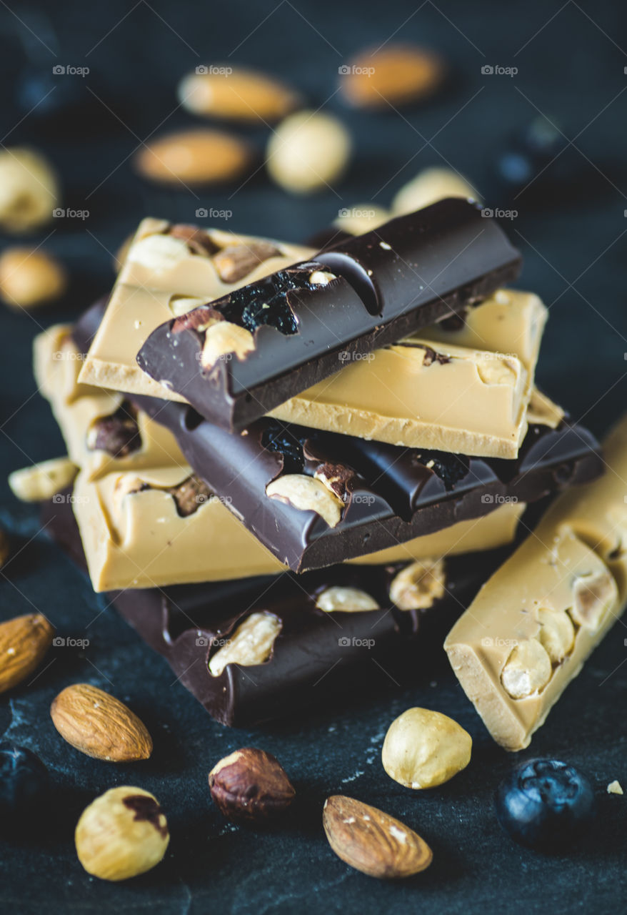 Stack of white and dark chocolate with almonds