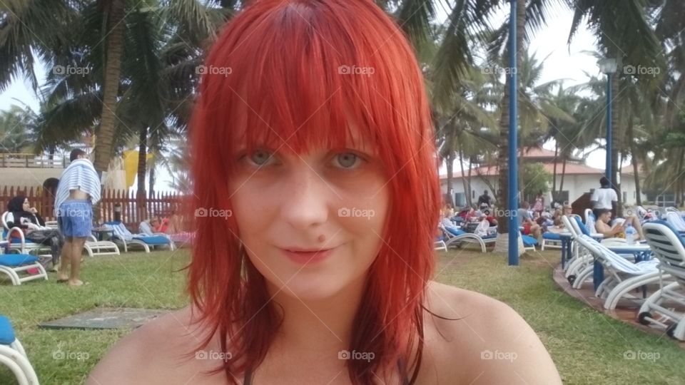 beach selfie. redhead by poolside in Africa