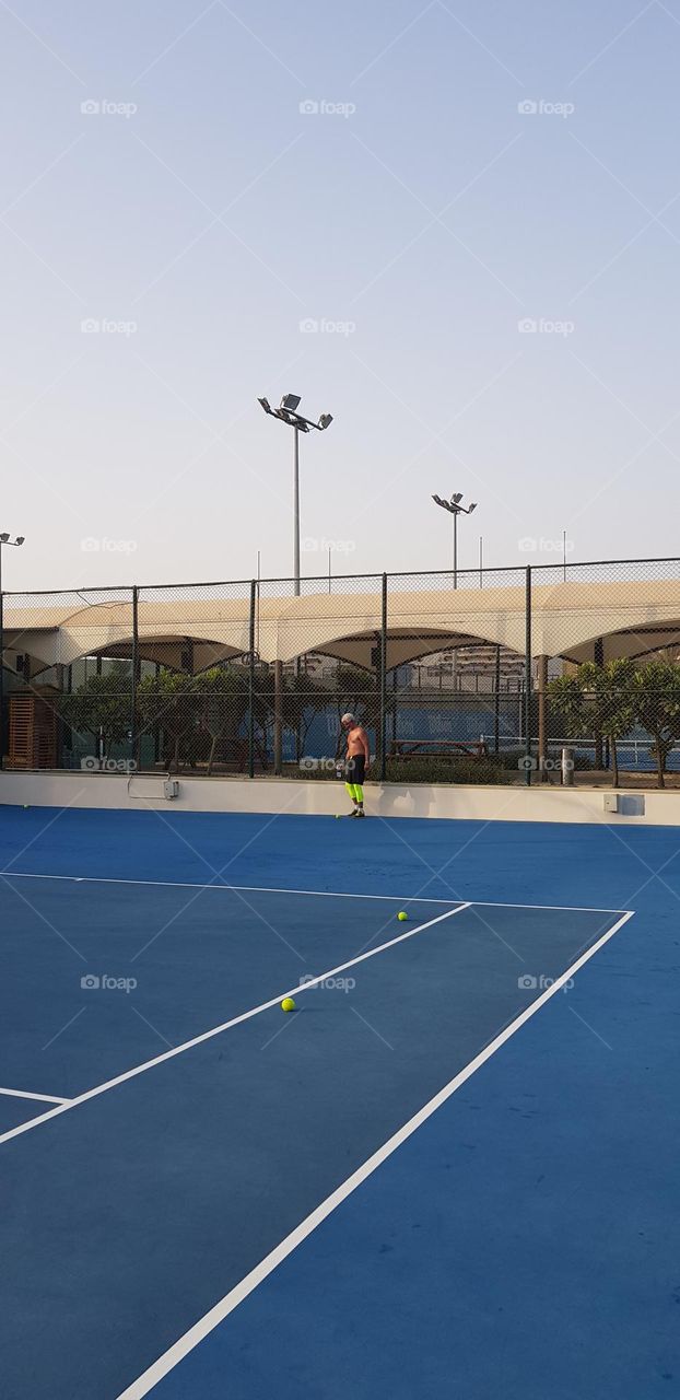 Playing tennis in Zayed Sports City