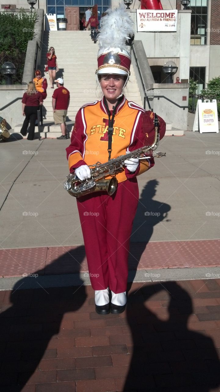 Woman in uniform standing with trumpet
