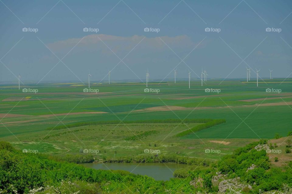 Field with wind turbines to produce green energy