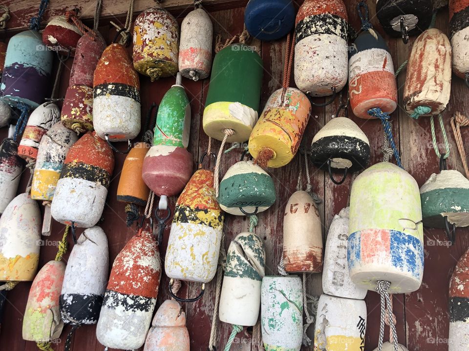 Colorful buoys hanging on the outside wall at an ocean side bar