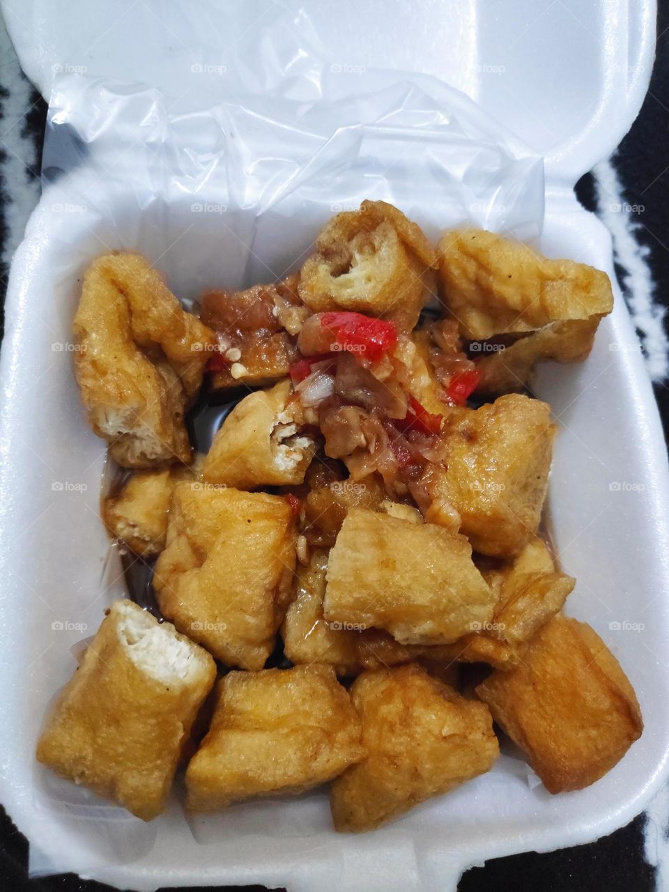 tofu with a chili sauce on a case