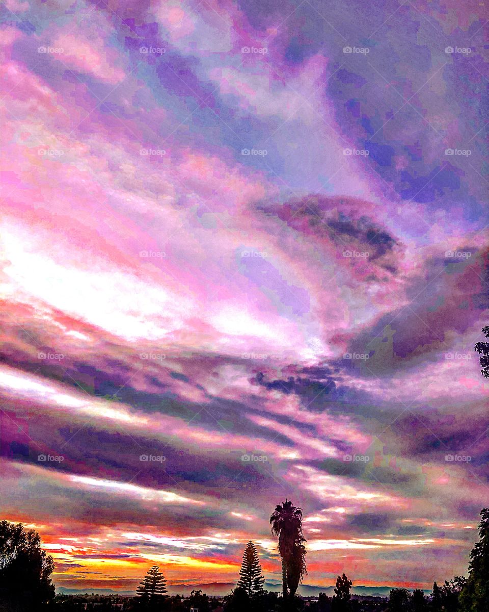 California sunset purple desert sky palms mountains clouds distant storm 